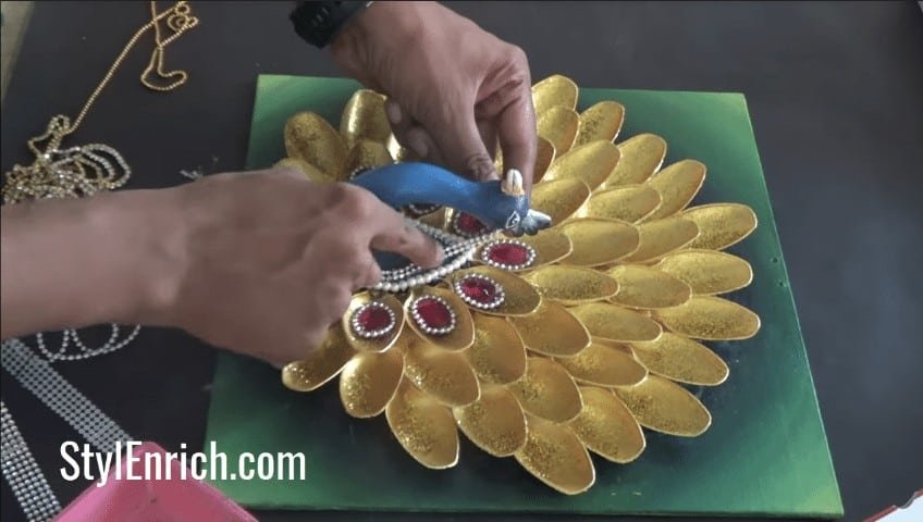 creative peacock using plastic spoons