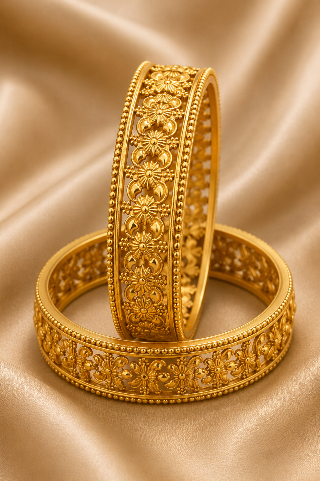 Latest Gold Bangle Designs That Define Timeless Elegance Floral Filigree Gold Bangles: These gold bangles have open floral filigree work and neat beaded edges for a rich and elegant traditional jewelry look.