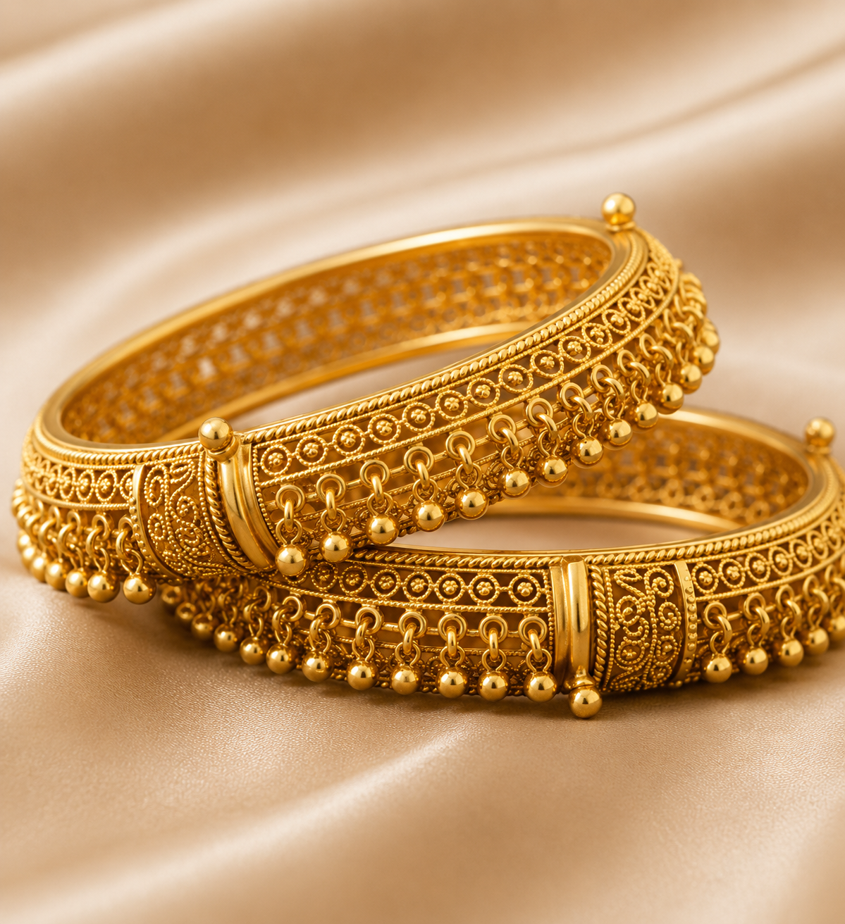 Latest Gold Bangle Designs That Define Timeless Elegance Antique Jhumka Bangles: These antique gold bangles have fine carved patterns and tiny hanging beads for a rich traditional jewelry look.
