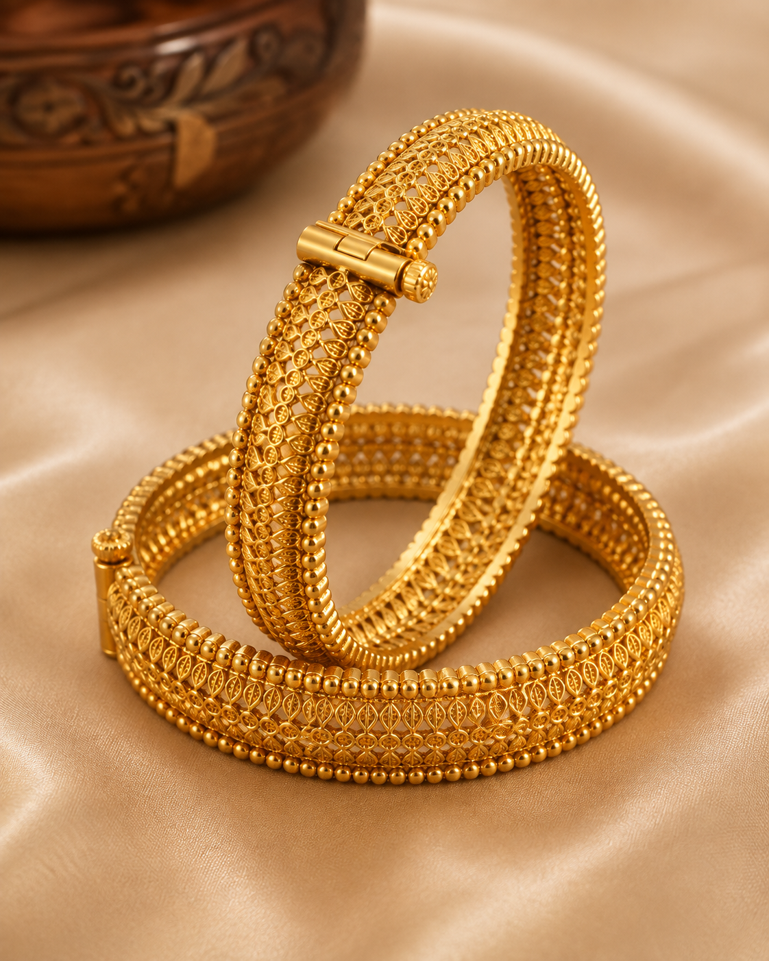 Latest Gold Bangle Designs That Define Timeless Elegance Textured Gold Kada Bangles: These antique gold kada bangles have rich leaf-like texture and neat beaded edges for a bold traditional jewelry look.