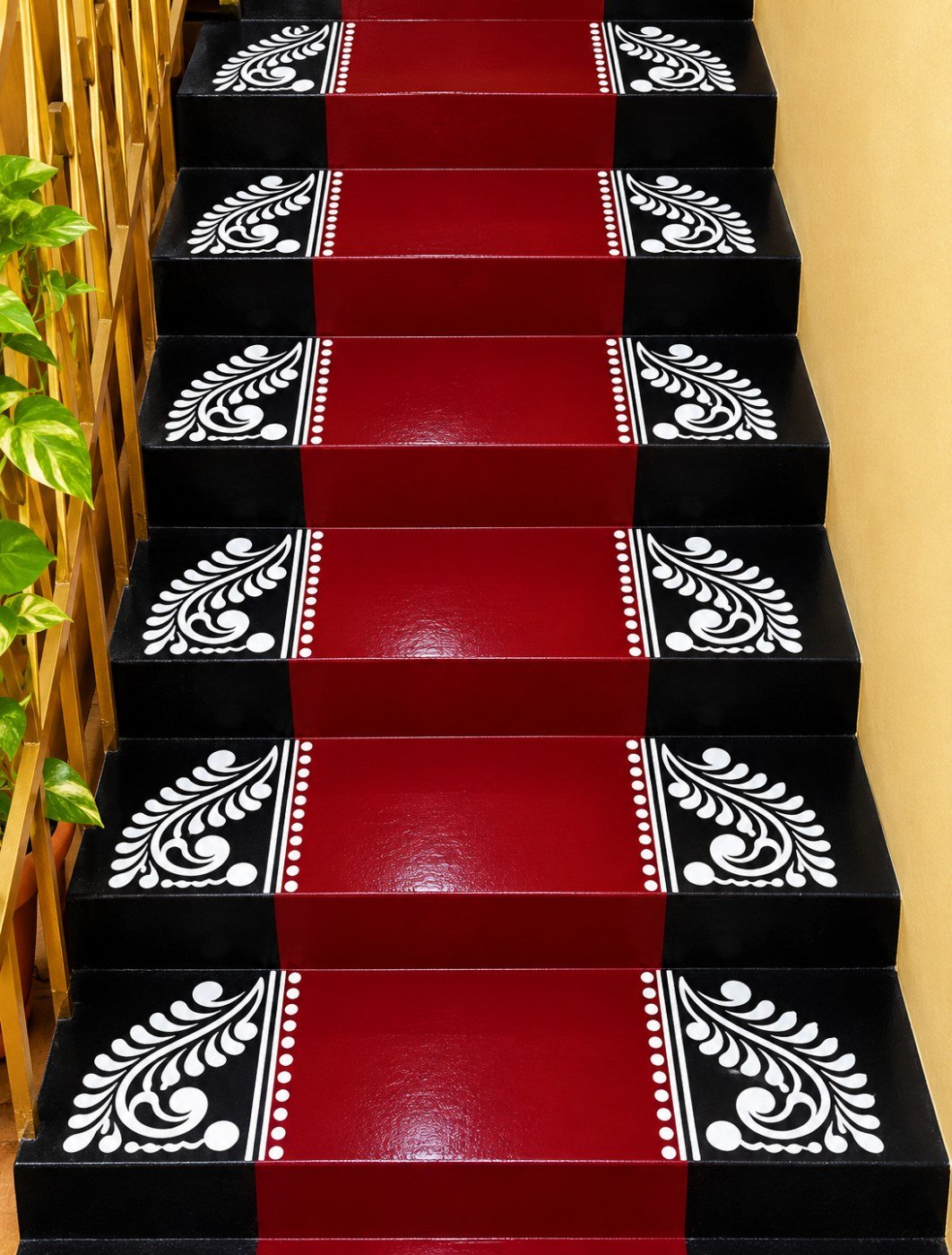 10 beautiful rangoli design ideas for entrances, stairs and floors Red and black staircase with repeated white paisley-style rangoli patterns on the corners of every step.