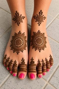 Feet with symmetrical floral mehndi motifs on the ankles, circular designs on the feet and decorated toes